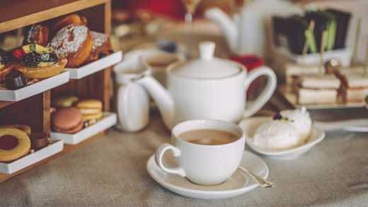 a scene from afternoon tea and high tea. A cup of chai hai instant tea with pastries and meals.